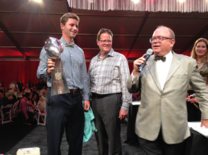 Steven Hauschka, placekicker for the defending Super Bowl champion Seattle Seahawks, is joined on stage, left to right, by Marty Clubb of L'Ecole No. 41 and auctioneers Fritz Hatton and Ursula Hermancinski on Saturday, Aug. 16, 2014. Hauschka's appearance with the Vince Lombardi Trophy was among the highlights at The Wine Gala, the finale for the Auction of Washington Wines. The three-day event has raised more than $30 million since its inception in 1988 for Seattle Children’s Hospital and wine research at Washington State University.