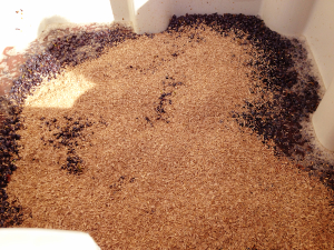 Malbec harvested from the Horse Heaven Hills receives a dusting of oak shavings before heading into a fermenting tank.