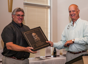 Roger Gamache, left, presents Allen Shoup with his plaque during the 2014 induction ceremony into the Legends of Washington Wine Hall of Fame in Prosser. (Photo by Cherished Moments Photography)