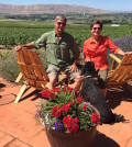 Larry Pearson and his wife, Jane, entertain Hugo, the youngest of their two standard poodles, on their Red Mountain patio at Tapteil Vineyard and Winery in Benton City, Wash.