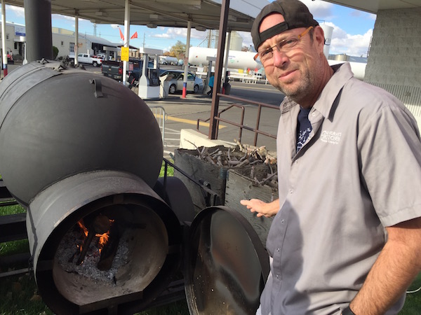 Andrae Bopp only uses apple wood in "Buehler" smoker near the Cenex Co-op at Rose and Ninth in Walla Walla, Wash. He plans to begin retailing his smoked bacon to customers, but he said he will never use the Buehler to smoke fish.