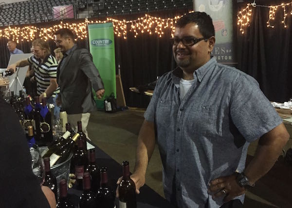 Freddy Arredondo pours wine at the Wenatchee wine festival.