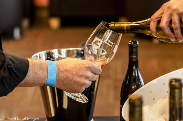 A patron enjoys a glass of wine at the WSU Wine & Jazz Festival in June in Richland. The event was part of the Auction of Washington Wines. (Photo by Richard Duval)