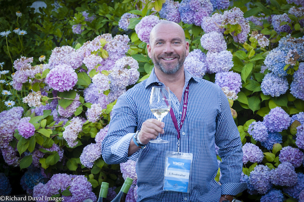 John Bookwalter, owner of Bookwalter Winery in Richland and Woodinville, raises a toast at the WSU Wine & Jazz Festival in Richland. (Photo by Richard Duval)