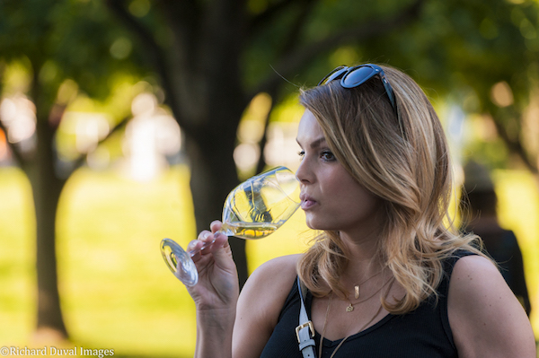 A patron enjoys wine at the WSU Wine & Jazz Festival in Richland, which was part of the Auction of Washington Wines. (Photo by Richard Duval)