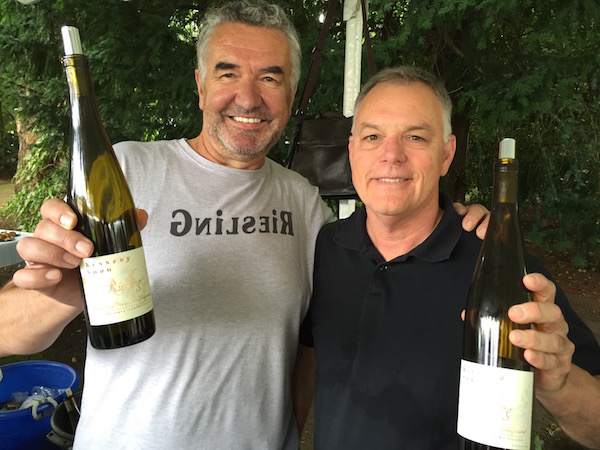 Jean Claude Beck, left, winemaker for Kennedy Shah, and sports writer Jim Riley pour at the grand tasting of Riesling Rendezvous on Sunday, July 17, 2016 in Woodinville, Wash. (Photo by Eric Degerman/Great Northwest Wine)