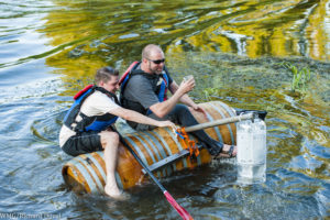John Patterson of Patterson Cellars uses wine barrels as a flotation device for the kayak portion of the Woodinville Winemaker, Brewer and Distiller Triathlon