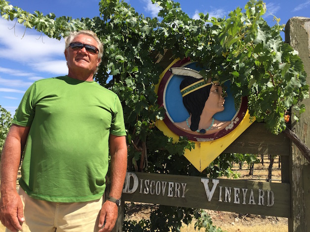Milo May, a grower in Alderdale, Wash., stands next to the sign for his Discovery Vineyard. The young site in the Horse Heaven Hills produced most of the grapes for the Passing Time 2012 Cabernet Sauvignon - Great Northwest Wine's No. 1 wine for 2015.